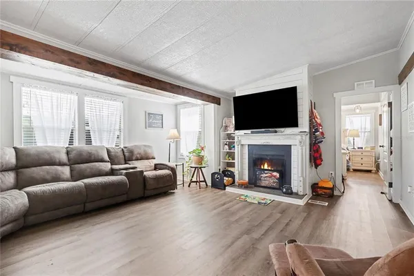 a living room with furniture a fireplace and a flat screen tv