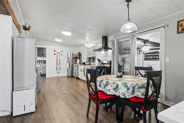 a view of a dining room with furniture and chandelier
