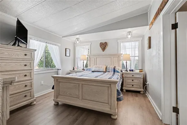 a kitchen with a stove and a flat screen tv