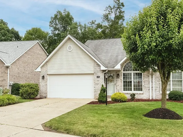 a view of a yard in front view of a house