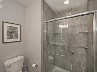a bathroom with a shower and toilet