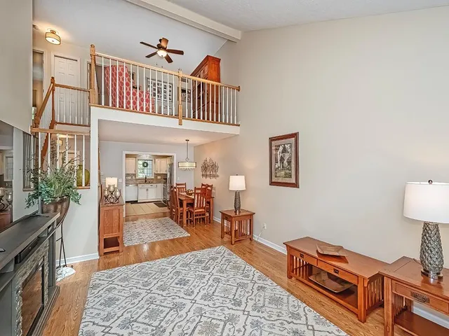 a living room with furniture a rug and a table