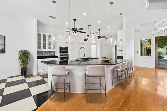 a bathroom with a granite countertop toilet and a sink