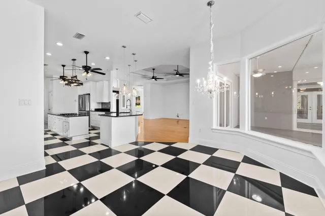 a view of a room with wooden floor and fan