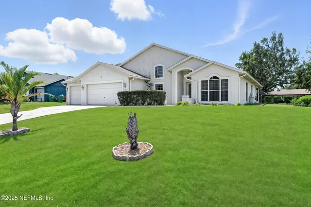 a front view of house with a garden and yard