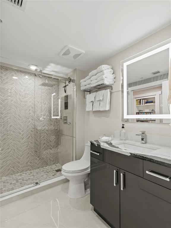 2700 North Federal Highway, Unit 407 Boynton Beach, FL 33435 - Photo 22 of 31 a bathroom with a sink a toilet and shower