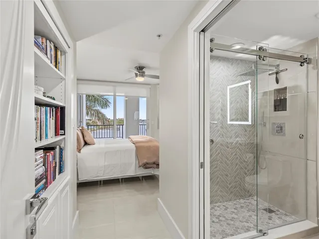 a bedroom with a large bed and a chandelier