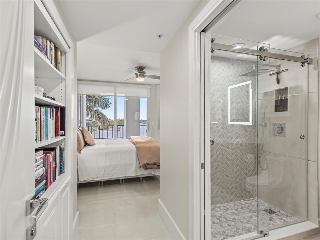 2700 North Federal Highway, Unit 407 Boynton Beach, FL 33435 - Photo 23 of 31 a bedroom with a bed and a book shelf