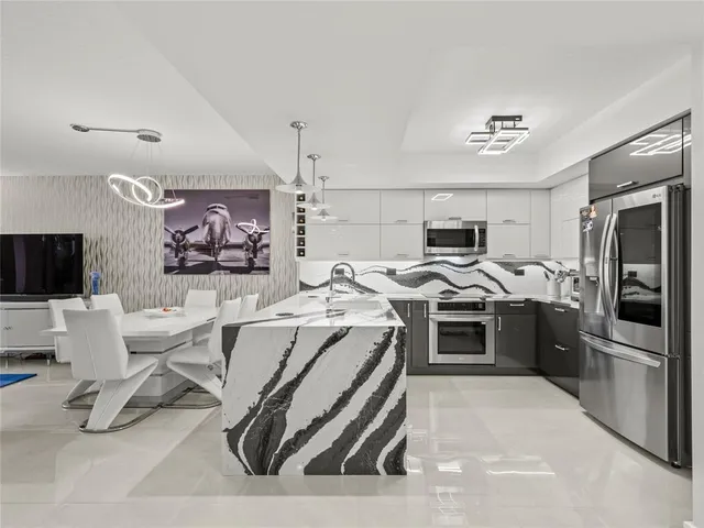 a kitchen that has a lot of cabinets a sink and a stove in it