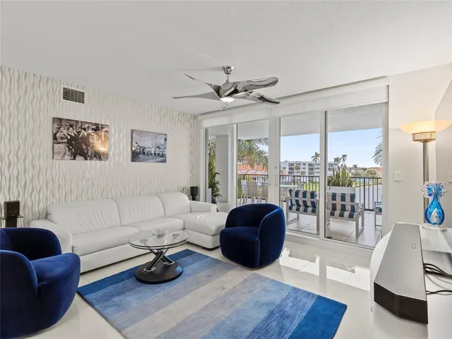 a living room with furniture a rug and a chandelier
