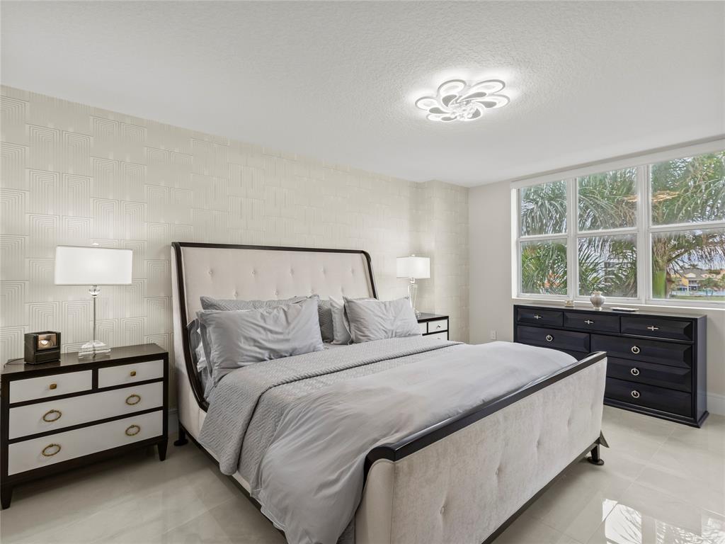 2700 North Federal Highway, Unit 407 Boynton Beach, FL 33435 - Photo 8 of 31 a bedroom with a bed and a night stand