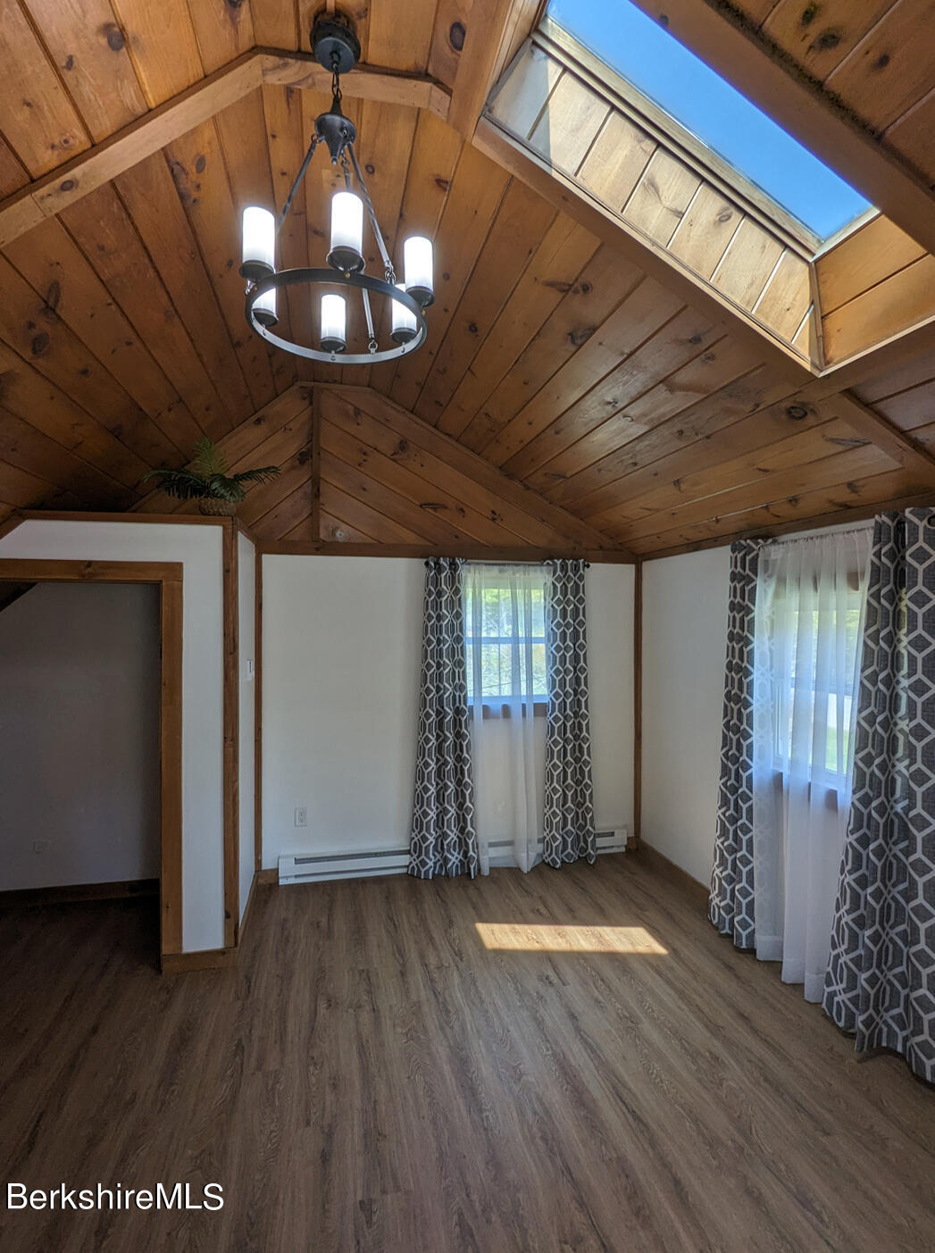 1430 Old Rte 9 Windsor, MA 01270 - Photo 9 of 24 an empty room with wooden floor chandelier fan and windows