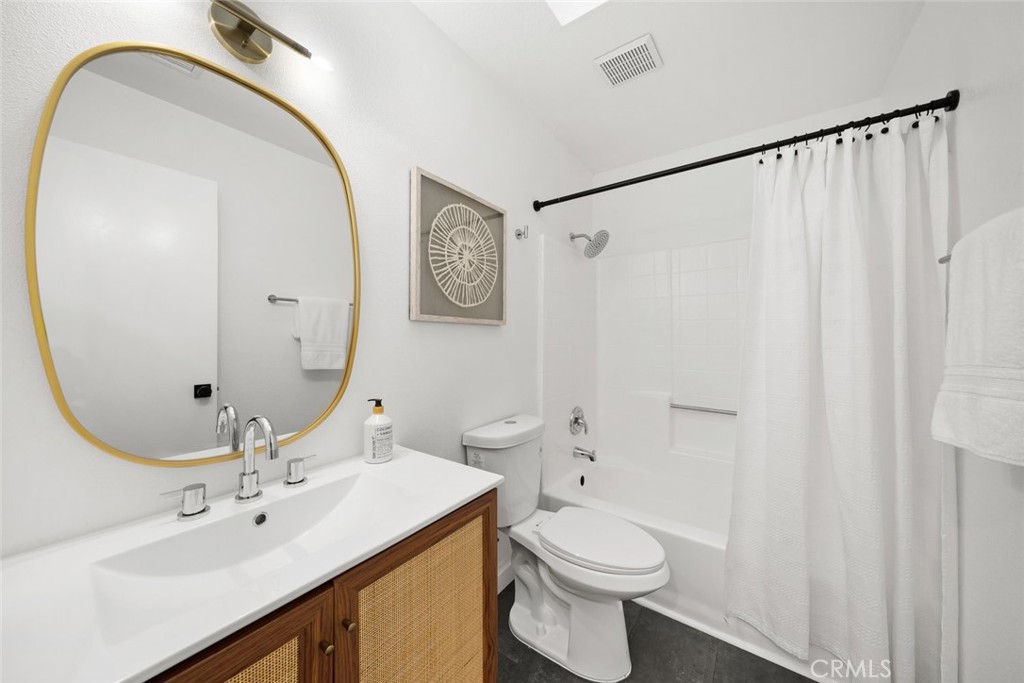 928 Austin Court Paso Robles, CA 93446 - Photo 29 of 30 a bathroom with a sink a toilet and a mirror