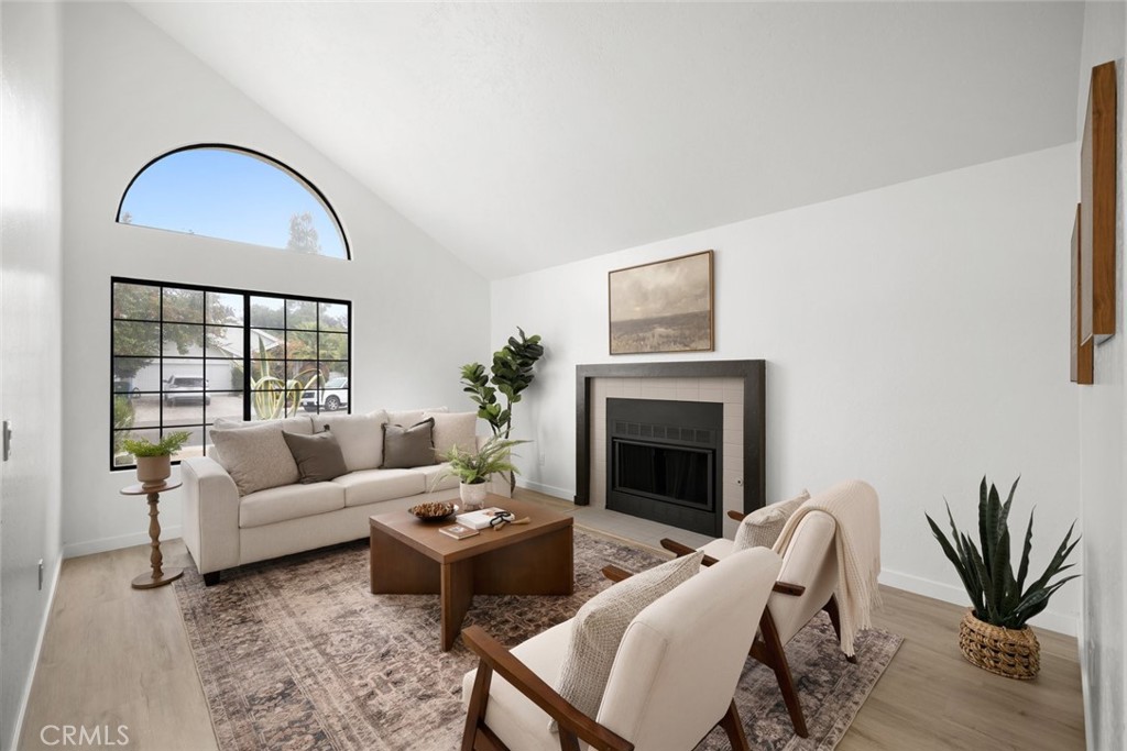 928 Austin Court Paso Robles, CA 93446 - Photo 3 of 30 a living room with furniture a fireplace and a potted plant