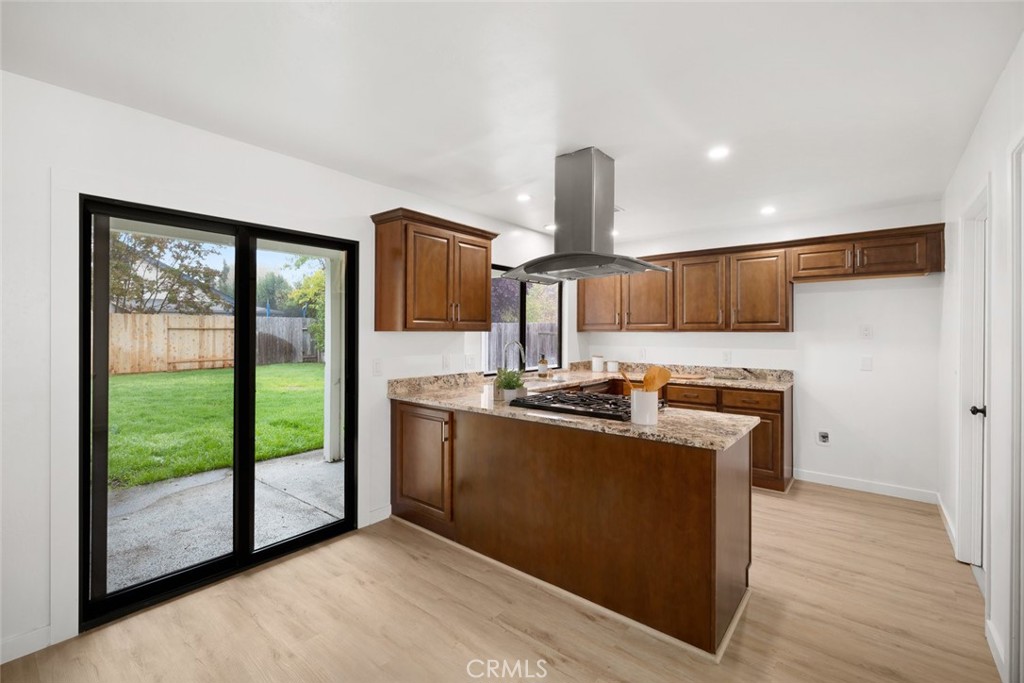 928 Austin Court Paso Robles, CA 93446 - Photo 7 of 30 a kitchen with stainless steel appliances granite countertop a refrigerator a sink and a wooden floors