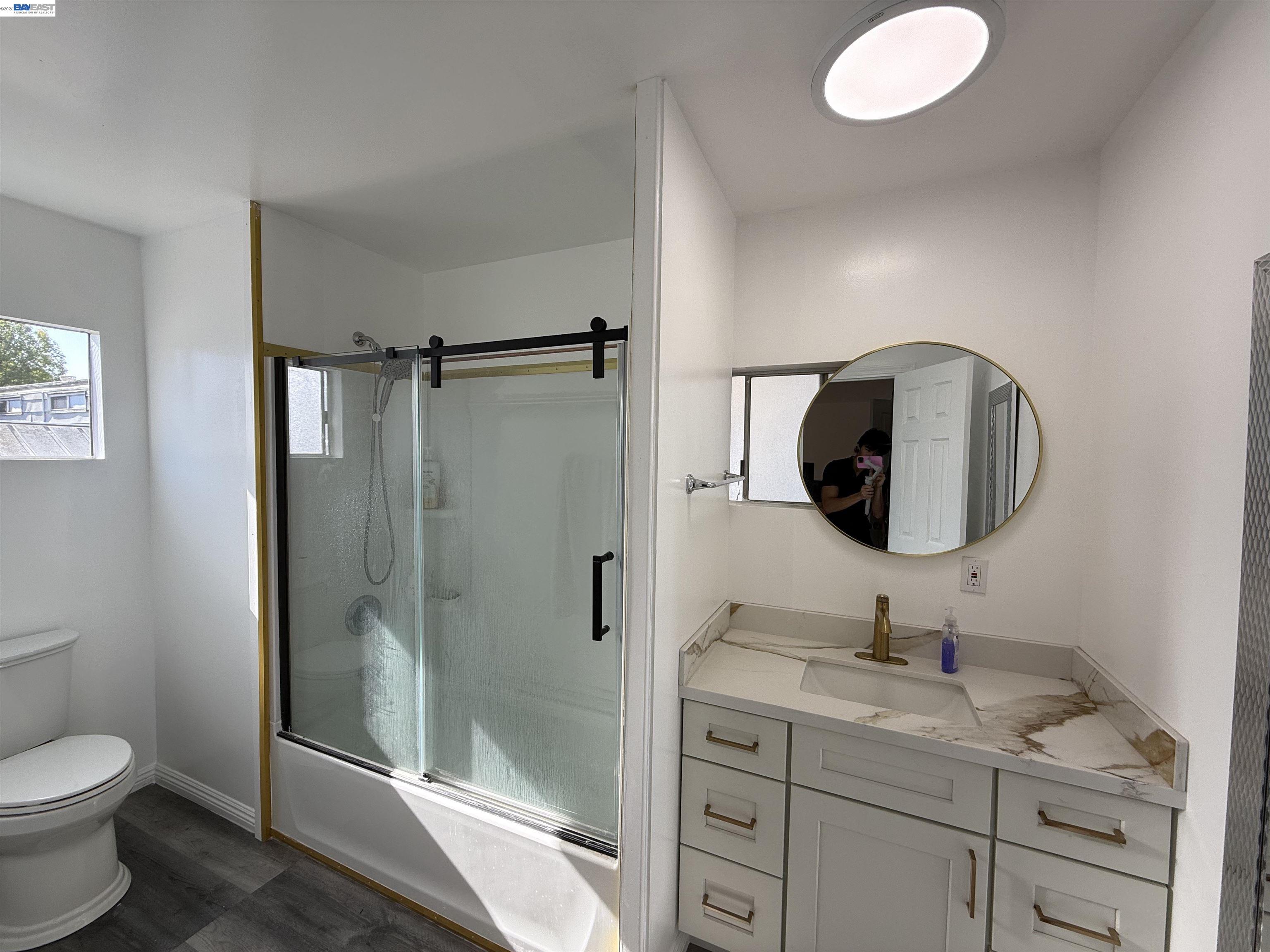 2151 Oakland Road, Unit 324 San Jose, CA 95131 - Photo 2 of 14 a bathroom with a granite countertop sink toilet and shower