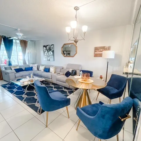 a living room with lots of furniture and a window