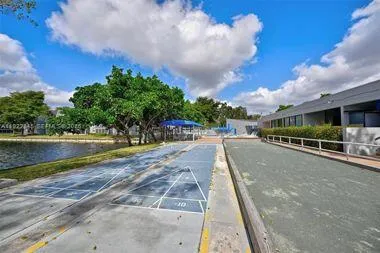a view of swimming pool with outdoor seating and lake in the background