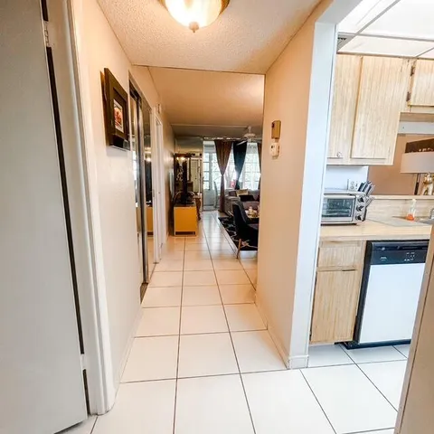 a kitchen with stainless steel appliances a refrigerator a sink a stove a microwave and cabinets