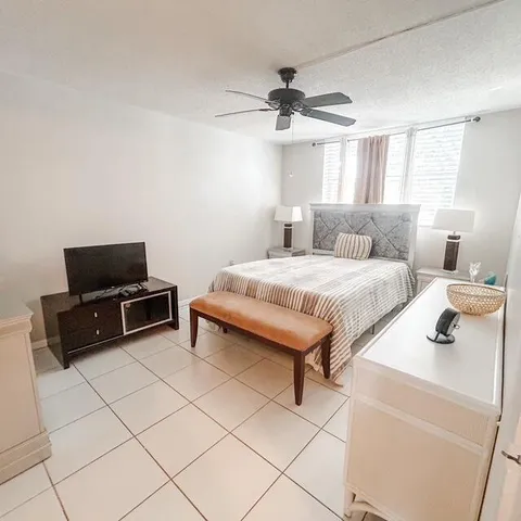 a bedroom with a bed and a television