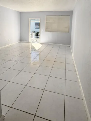 a view of an empty room and a window