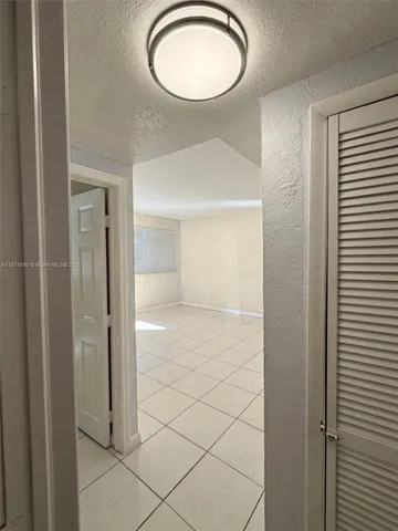 a view of a room with a mirror and a window