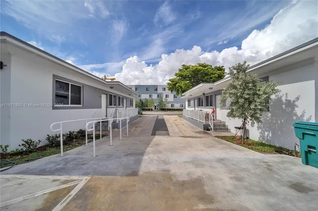 a view of a house with backyard porch and sitting area