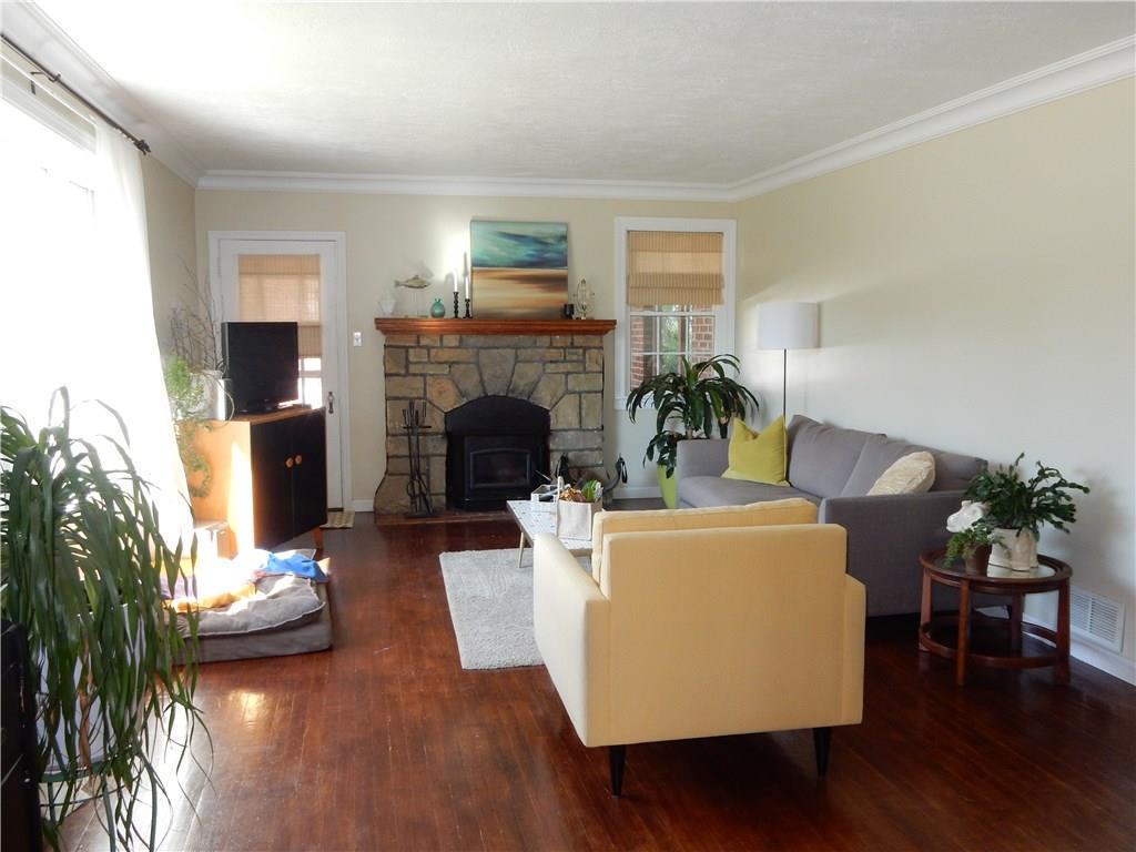 327 McClelland Road Canonsburg, PA 15317 - Photo 15 of 25 Relax in this cozy living room in front of the fireplace on those cold winter nights. Hardwood floors, log burning buck stove insert in the stone fireplace as well as entry to the side porch.