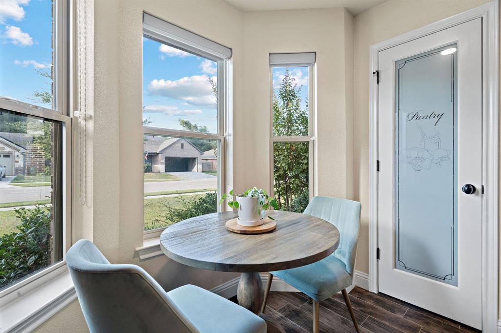 904 Sam Street Springtown, TX 76082 - Photo 11 of 30 a view of a dining room with furniture window and wooden floor