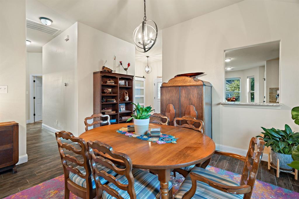 904 Sam Street Springtown, TX 76082 - Photo 14 of 30 a view of a dining room with furniture window and wooden floor