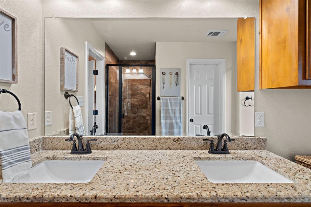 904 Sam Street Springtown, TX 76082 - Photo 17 of 30 a bathroom with a granite countertop sink and a mirror