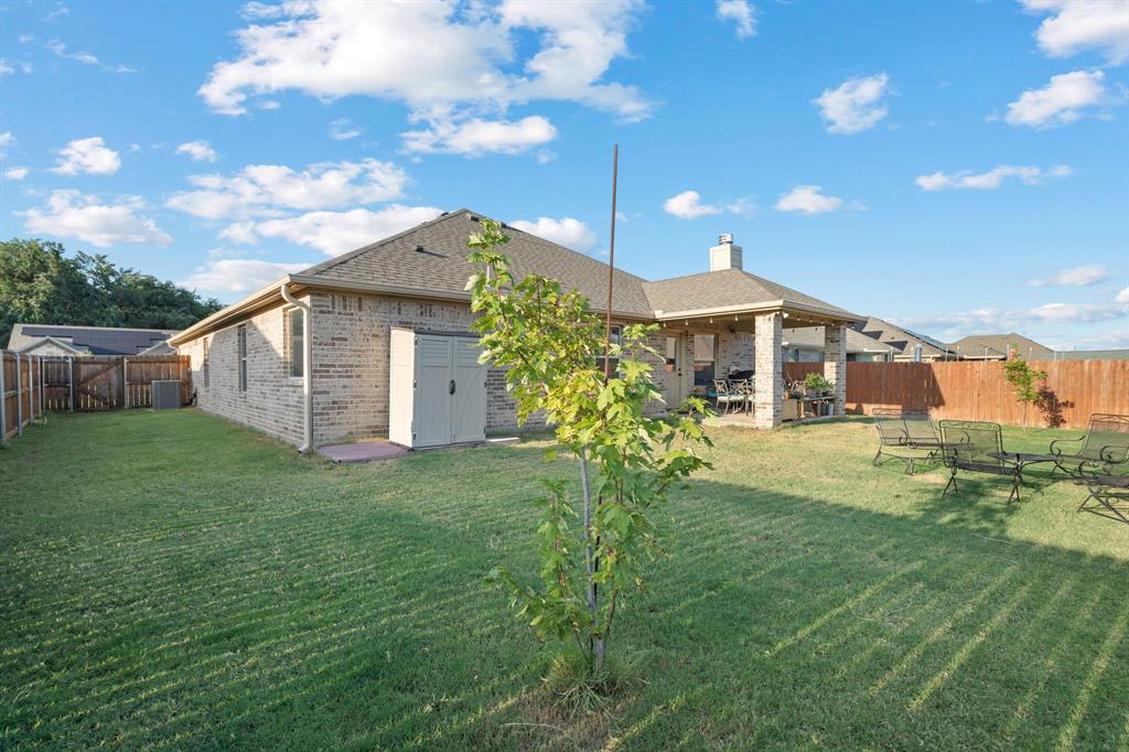 904 Sam Street Springtown, TX 76082 - Photo 25 of 30 a view of a house with a back yard