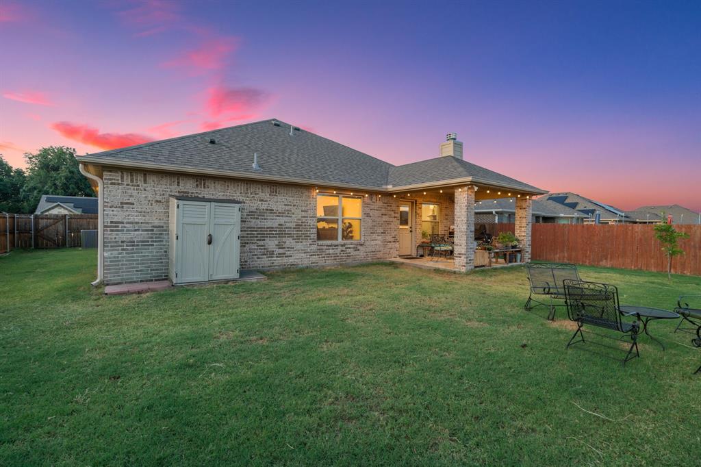 904 Sam Street Springtown, TX 76082 - Photo 27 of 30 a view of a house with a backyard