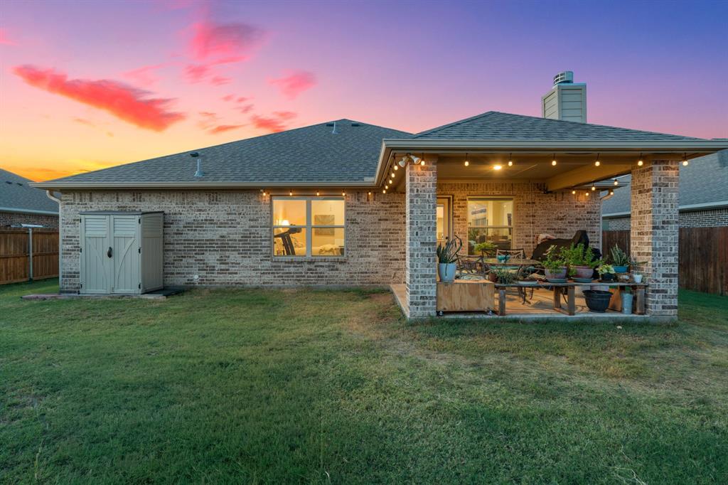 904 Sam Street Springtown, TX 76082 - Photo 28 of 30 a front view of a house with a garden and patio