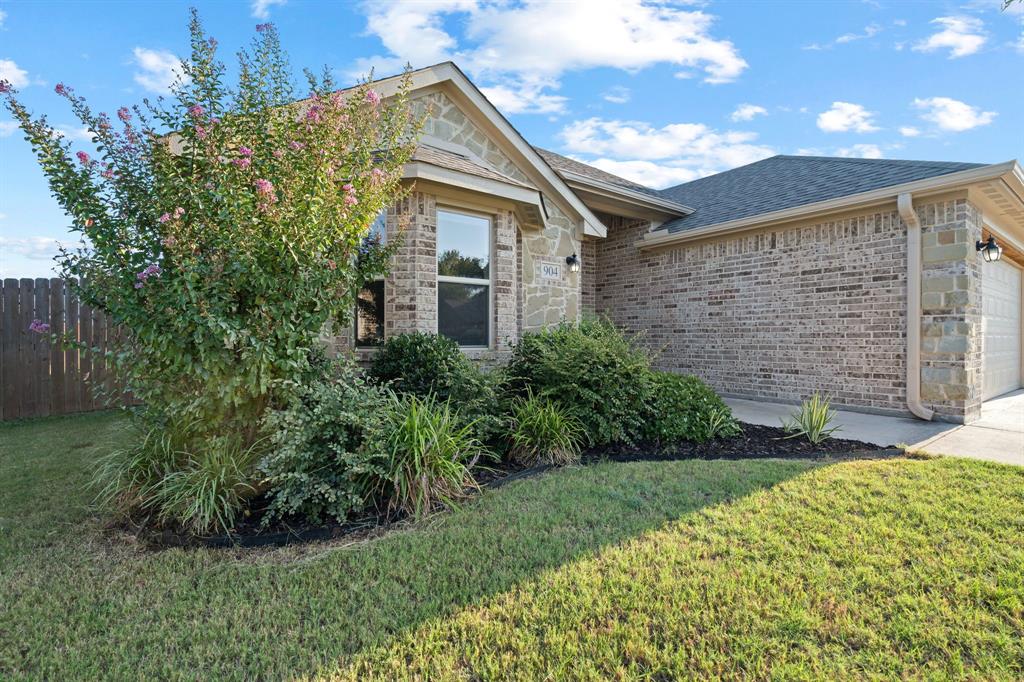904 Sam Street Springtown, TX 76082 - Photo 3 of 30 a front view of a house with garden