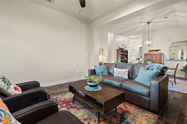 a living room with furniture and wooden floor