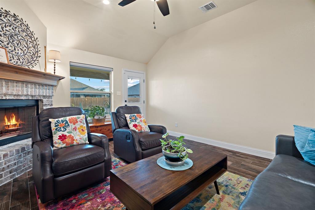 904 Sam Street Springtown, TX 76082 - Photo 7 of 30 a living room with furniture and a fireplace