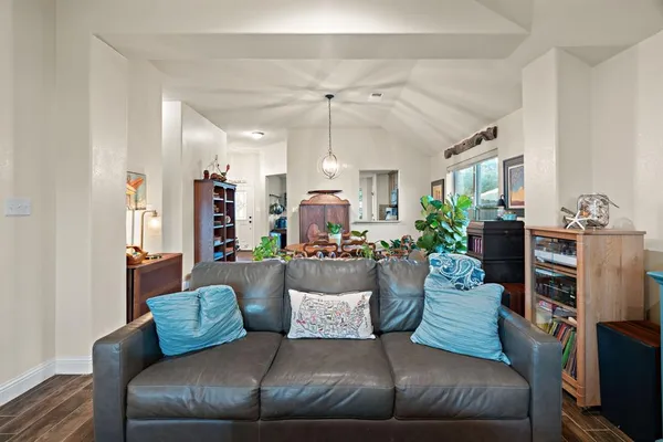 a living room with furniture and a chandelier