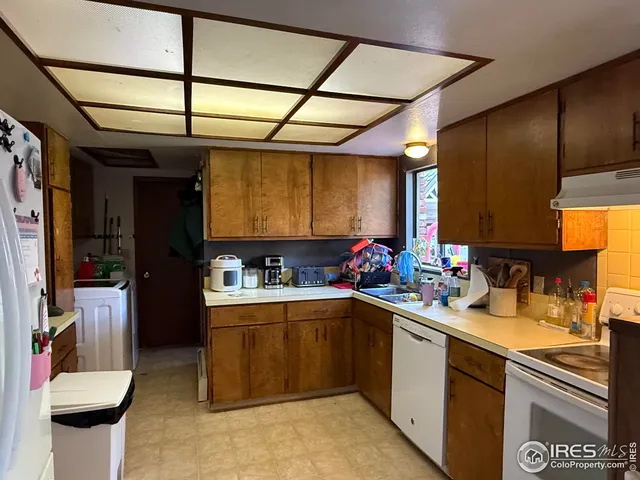 a kitchen with a sink cabinets and appliances
