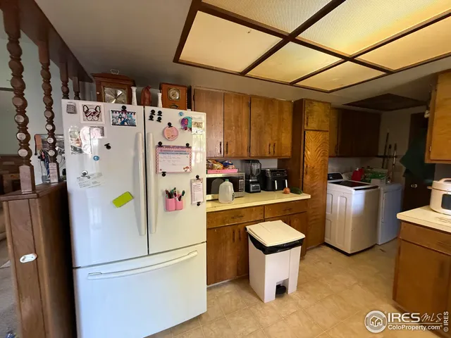 a white refrigerator freezer sitting in a kitchen