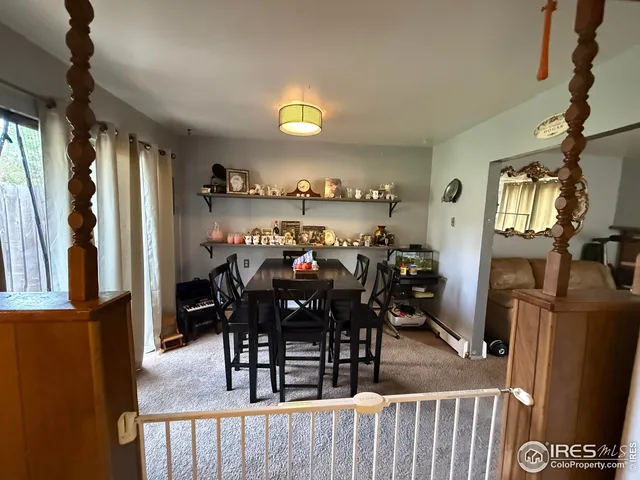 a view of a dining room with furniture and window