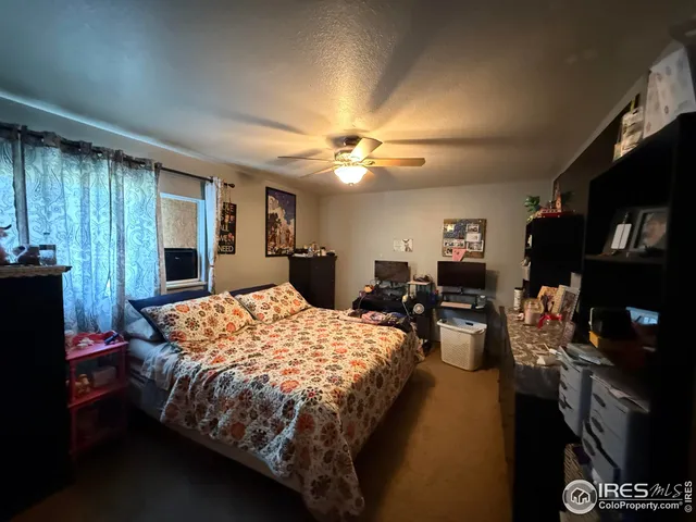 a bedroom with a bed and a dresser in it