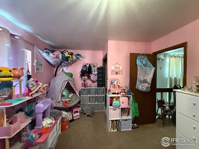 a bedroom with bed and window