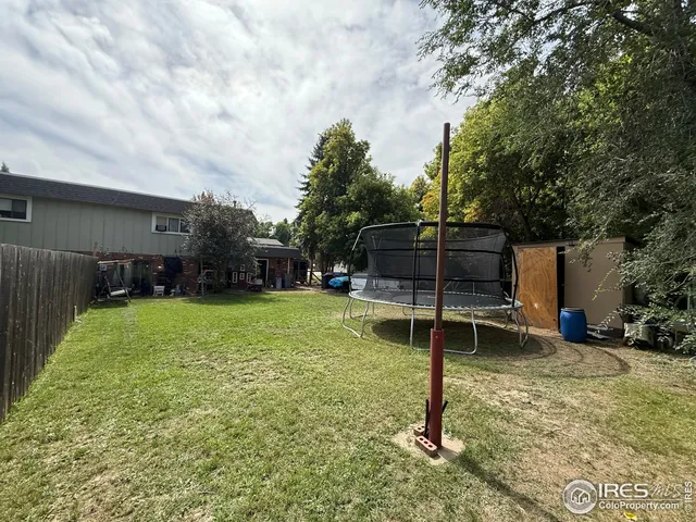 a view of a patio with table and chairs under an umbrella