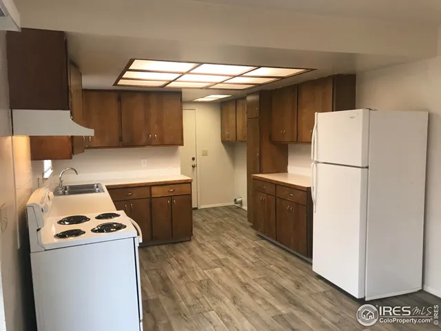 a kitchen with a refrigerator and a stove