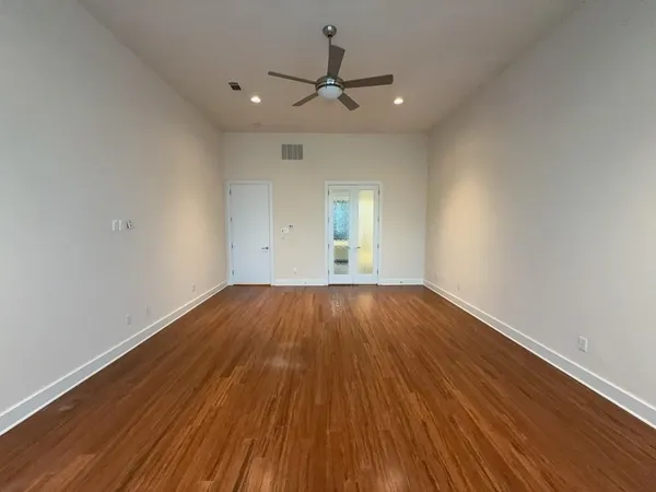 a view of walk in closet with empty racks