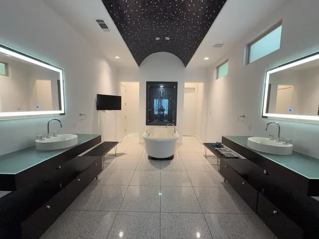 a room with pool table and windows