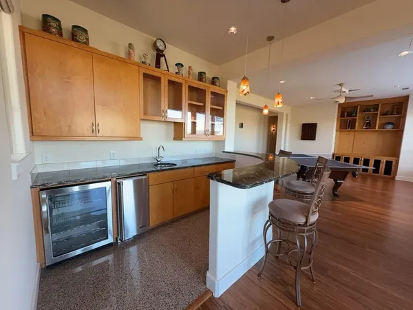 a dining room with furniture a rug and wooden floor