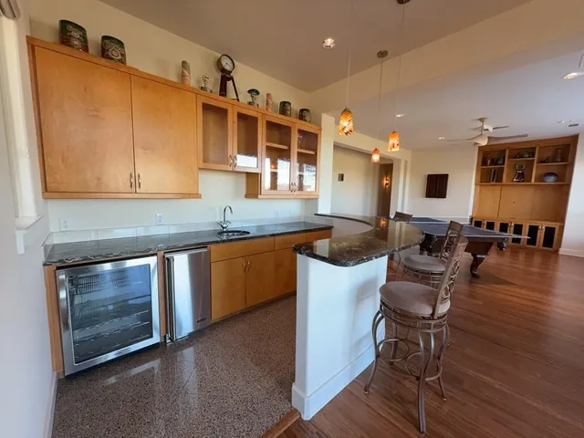 a dining room with furniture a rug and wooden floor