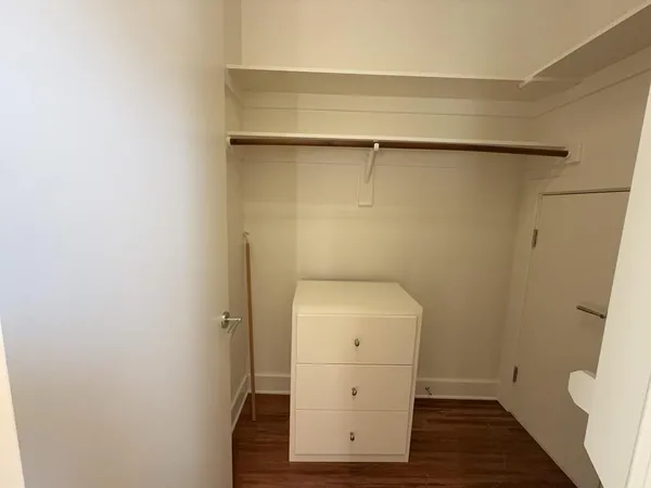 a bathroom with a granite countertop bathtub shower and toilet
